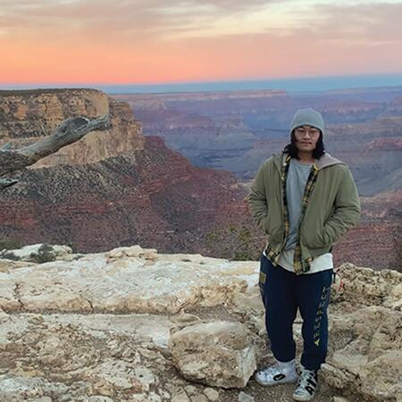 2023 DOIT Scholar Yu Tian standing at the Grand Canyon
